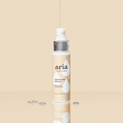 Aria haircare argan oil serum bottle on a beige background