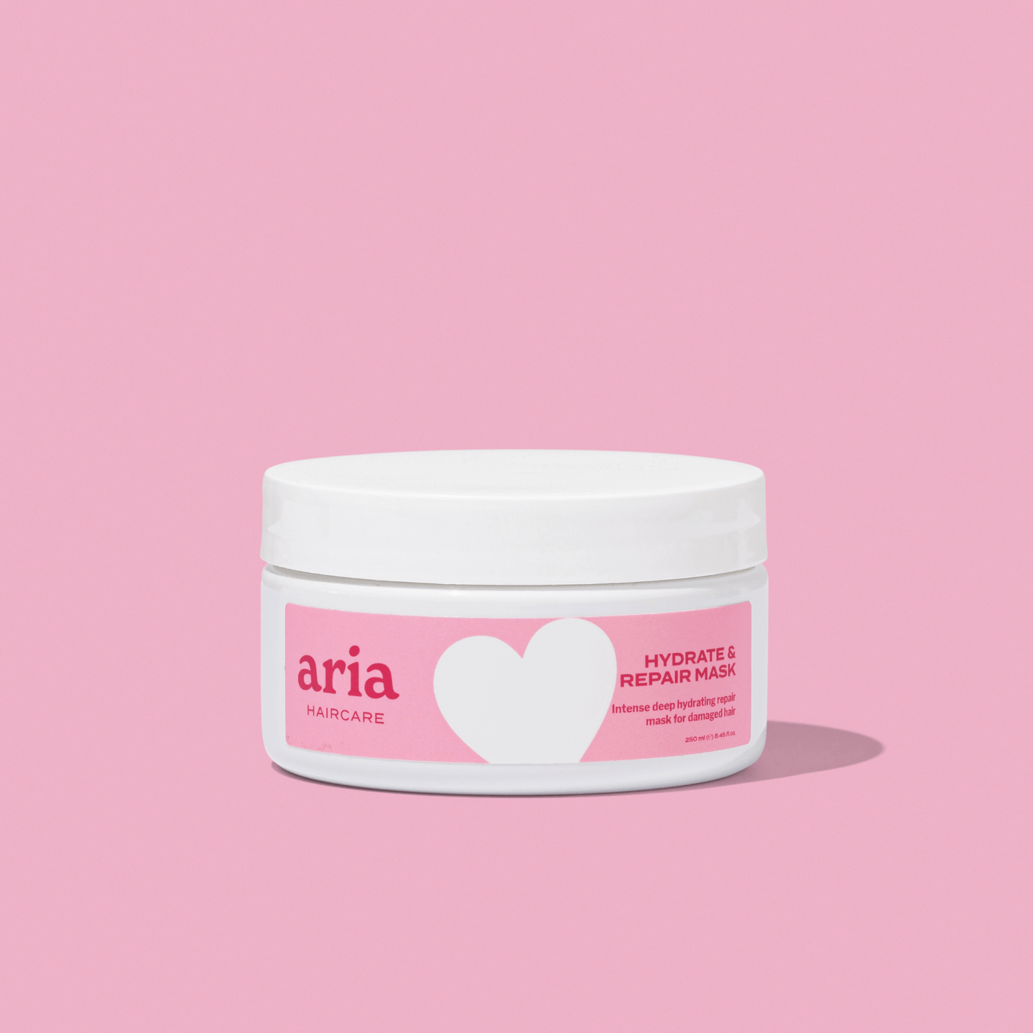Aria Haircare hydrate and repair mask on pink background