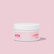 Aria Haircare leave in curl cream on pink background