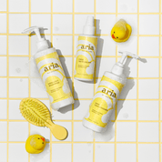 Aria haircare little locks trio kids shampoo, kids conditioner, kids detangler products with a yellow grid background