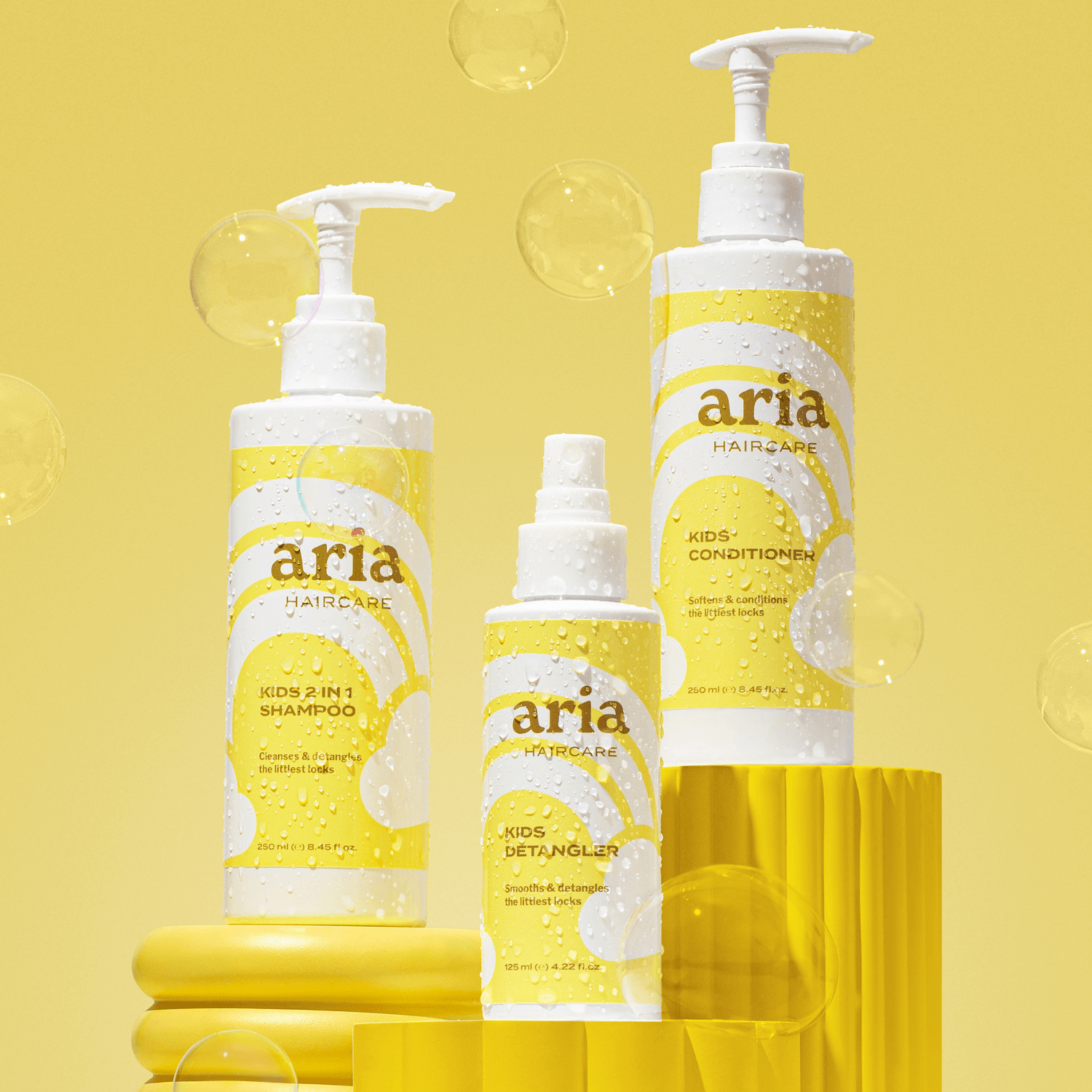 Aria haircare little locks trio products on a yellow background with bubbles