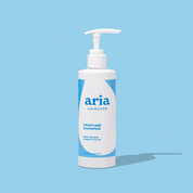 Aria Haircare moisture shampoo bottle on a light blue background