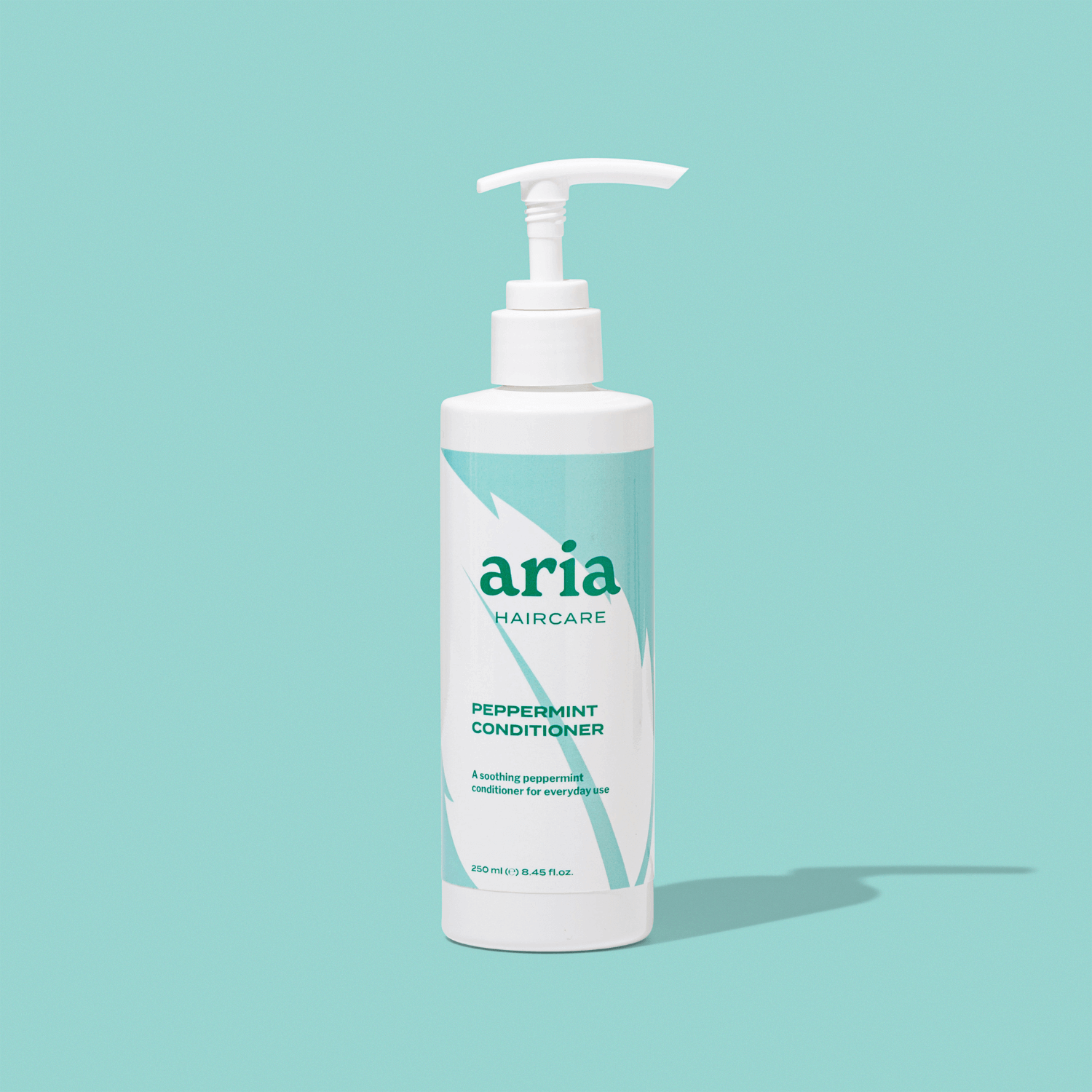 Aria Haircare peppermint conditioner bottle on a light blue background