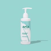 Aria haircare peppermint shampoo bottle on a light blue background