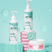 Aria Haircare Scalp Therapy peppermint shampoo, conditioner and hair mask trio on blue background with bubbles
