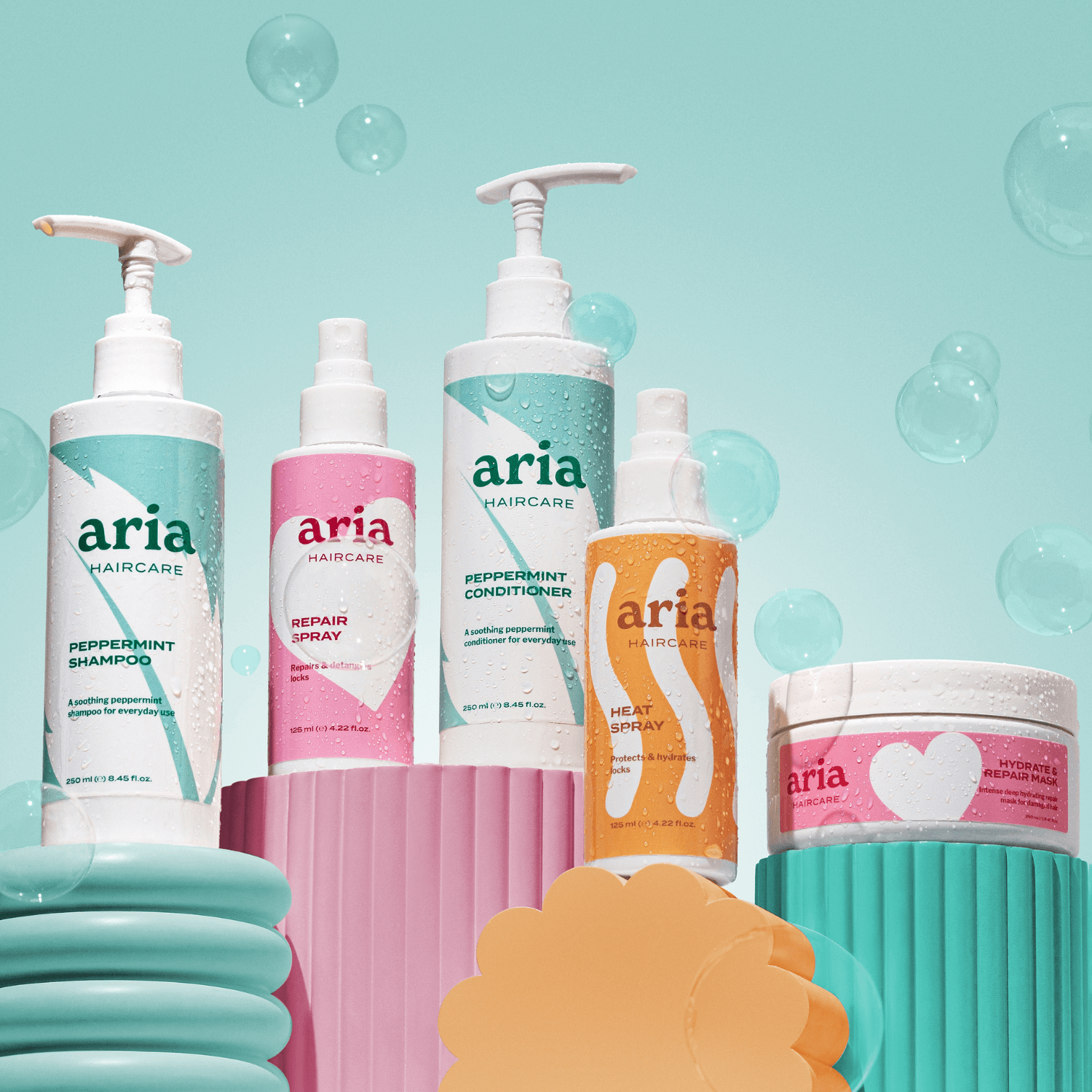 Aria Haircare Scalp to Strands Bundle on teal background with bubbles